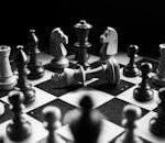 A captivating black and white photo of a chess game with fallen king piece, symbolizing defeat.