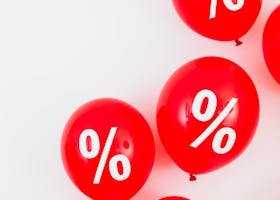 Red balloons featuring percentage symbols for sales and discounts on a white background.