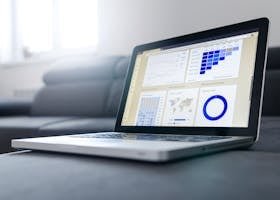 Sleek laptop showcasing data analytics and graphs on the screen in a bright room.